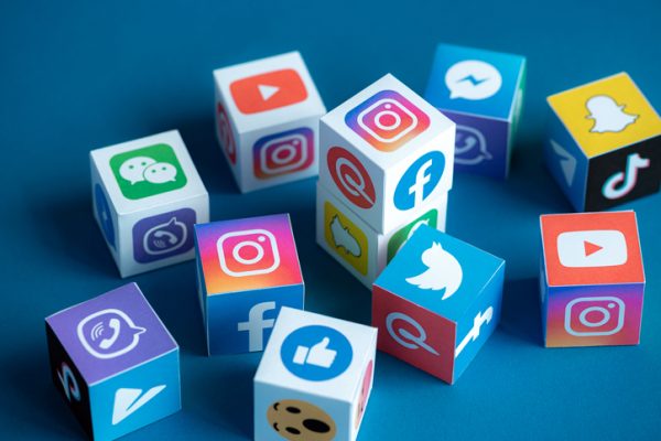 A paper cubes printed logos of social networks and online messengers, such as Facebook, Instagram, YouTube, etc