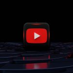 The YouTube play logo on a monitor in a darkened auditorium.