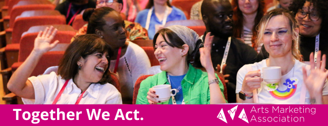 Three smiling people seated in an auditorium. Words: Together We Act. 