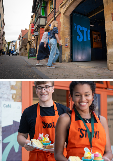 Two people happily walking through the open glass entrance doors. Two smiling team members with orange aprons with the logo of the Story Museum. 